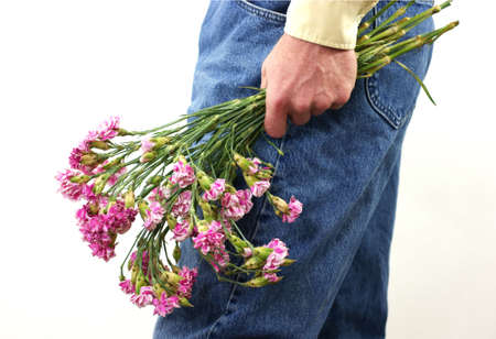 Old carnations in man's hand の写真素材