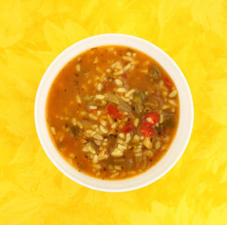 Hearty chicken soup in a white bowlの写真素材