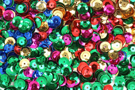 Close view of server al different colored sequins used for arts and crafts. 
