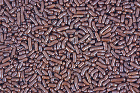 A close view of a layer of chocolate sprinkles for ice cream.の写真素材