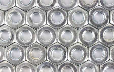 A close view of several rows of coarse thread hex nuts.の写真素材