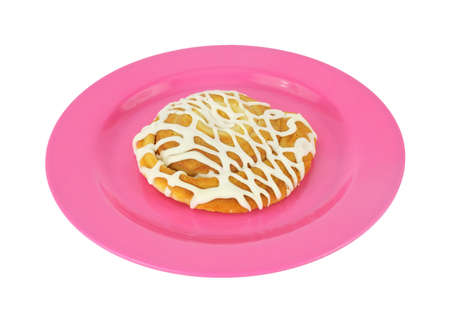 A fresh cheese danish on a pink plastic plate.の写真素材