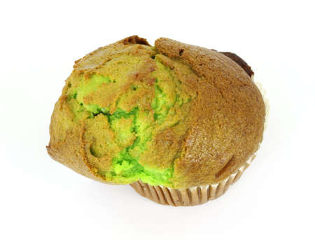 A freshly baked pistachio nut muffin on a white background.の写真素材