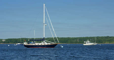 Sailboats and motorboats at their moorings off the coast of Maine.の写真素材