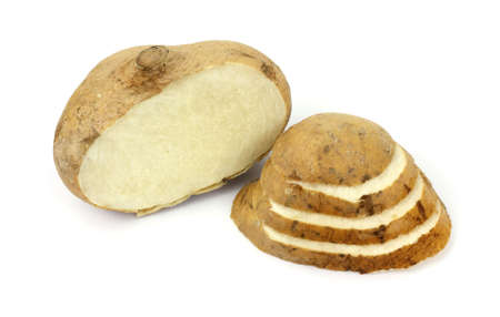 A jicama root that has been sliced and arranged on a white background.の写真素材