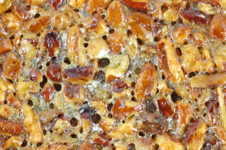 Very close view of the surface of a cooked pecan pie.の写真素材
