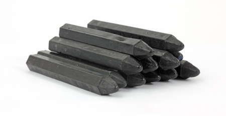 A group of carpenter's crayons in a stack on a white background.の写真素材