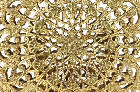 Close view of delicate gold filigree design.