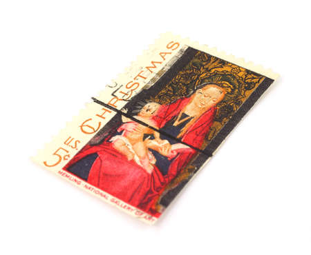 An old Christmas stamp of a child and Madonna on a white background.の写真素材