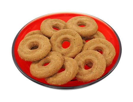 A red plate with several chocolate shortbread cookies on a white background.の写真素材