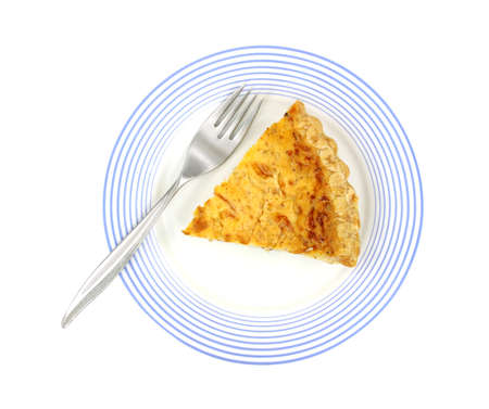 Above view of single slice of quiche lorraine on a blue striped plate with fork.の写真素材