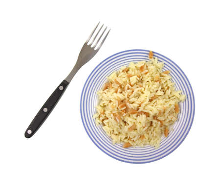 A small plate with a serving of rice pilaf and fork on a white background.の写真素材