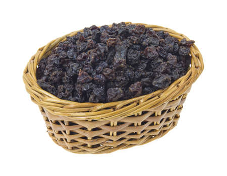 A small wicker basket filled with currants on a white background. の写真素材