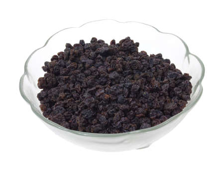 A small glass dish filled with currants on a white background.の写真素材