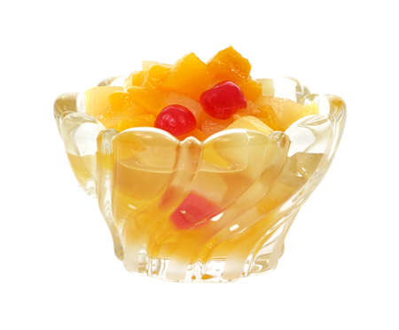Glass dish filled with fruit cocktail on a white background.の写真素材