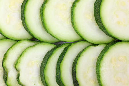A very close view of several slices of fresh zucchini. の写真素材