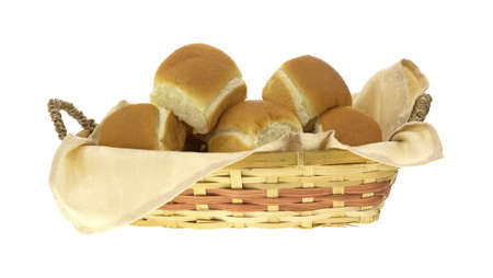 Side view of a colorful wicker basket filled with dinner rolls and napkin. の写真素材