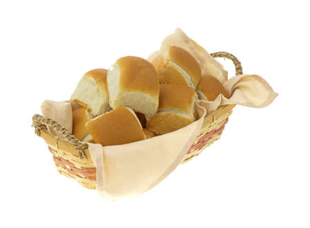 A small wicker basket filled with fresh dinner rolls.の写真素材