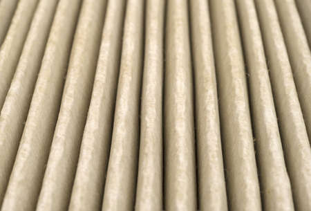 A very close view of the grooves of a used high efficiency particle type air filter that is clogged with dust and dirt.の写真素材