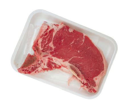 Top view of a t-bone steak in a white butcherの写真素材