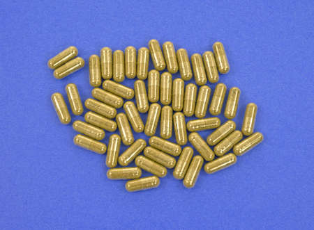 A group of echinacea dietary supplement capsules on a blue background.の写真素材