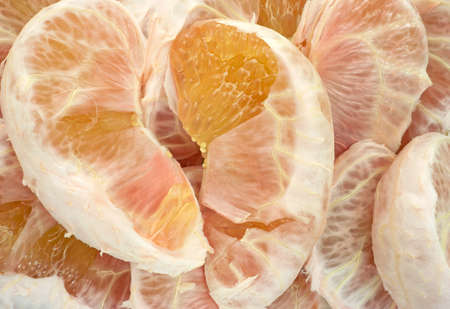 Close view of several pieces of pummelo fruit that have been peeled.の写真素材