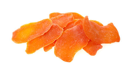 A small serving of dehydrated and candied mango slices on a white background の写真素材
