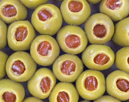 A very close view of the tops of pimento stuffed olives 