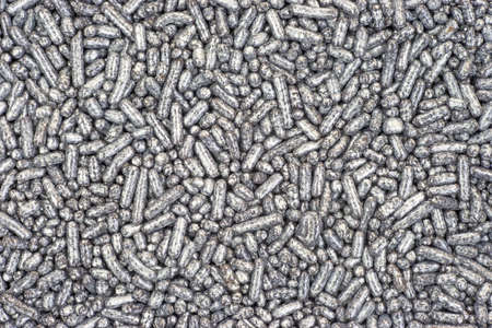 A very close view of silver sugar sprinkles の写真素材