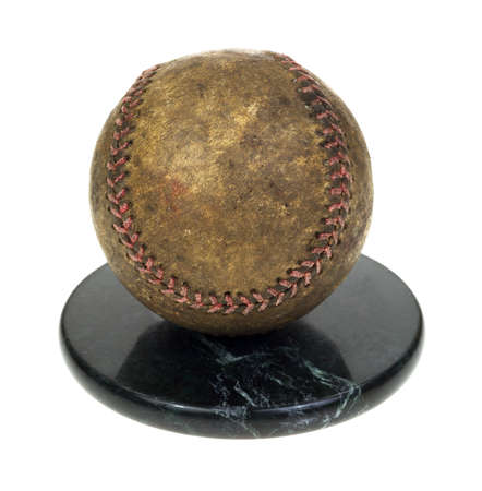 A baseball that has been overly used on a granite base 
