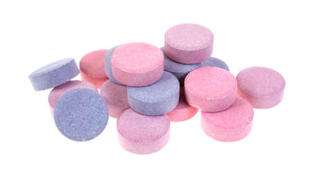A group of fruit flavored antacid tablets on a white background の写真素材