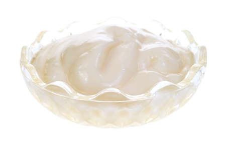 A small glass dish with plain vanilla yogurt on a white background の写真素材