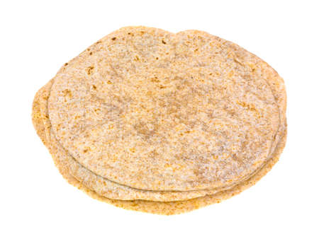 Several whole wheat tortillas in a stack on a white background の写真素材