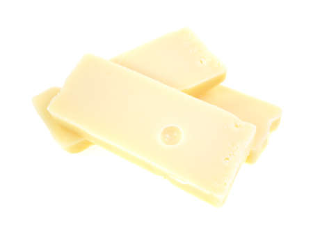 Three large chunks of aged Swiss cheese on a  white background.