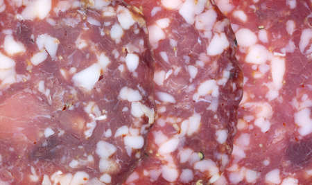 A very close view of three slices of sopressata cold cut meat の写真素材