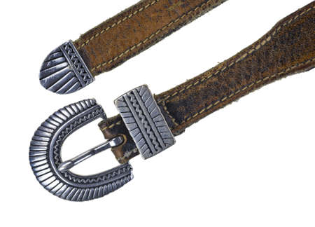 Close view of an old leather belt with ornate silver buckle.