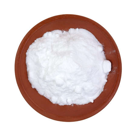 Top view of baking soda in a red clay bowl on a white background の写真素材
