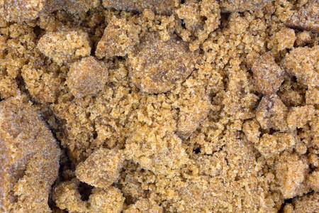 A very close view of clumpy dark brown sugar.の写真素材