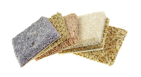 Several small squares of carpet samples on a white background.