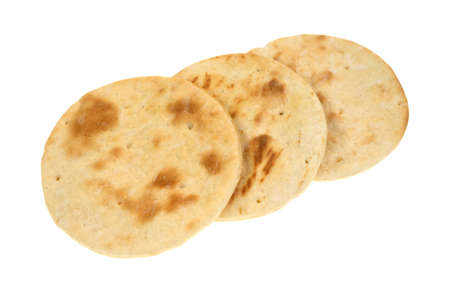 Three small pizza crusts that have been cooked on a white background.の写真素材