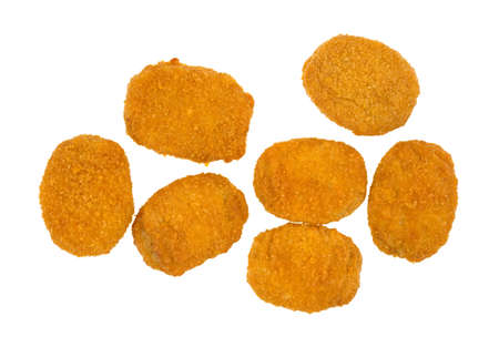 Top view of several cooked breaded chicken nuggets on a white background の写真素材