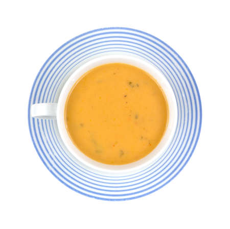A serving of gouda cheese soup in a coffee cup and saucer 