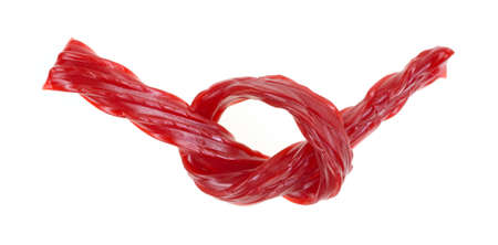 A piece of red licorice tied in a knot の写真素材