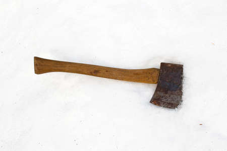 An old wood handle ax atop a snowbank.の写真素材