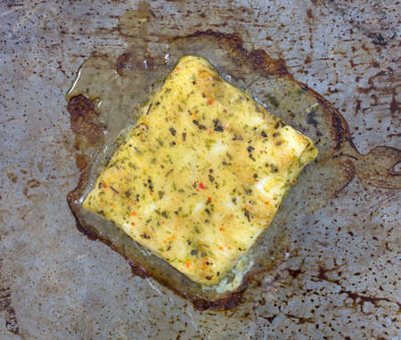 A fillet of baked Alaskan Pollock on an old pan の写真素材