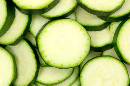 A very close view of several slices of summer squash.の写真素材