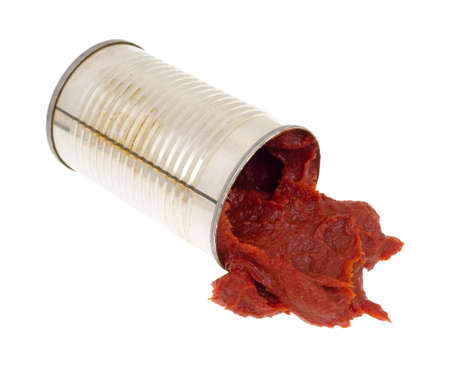 An opened can of tomato paste spilling onto a white background.