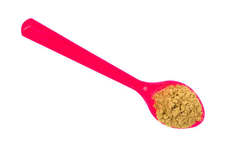 Top view of a large pink spoon with stir fry seasoning on a white background.の写真素材