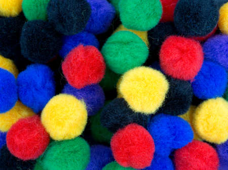 A very close view of colorful craft pompoms.