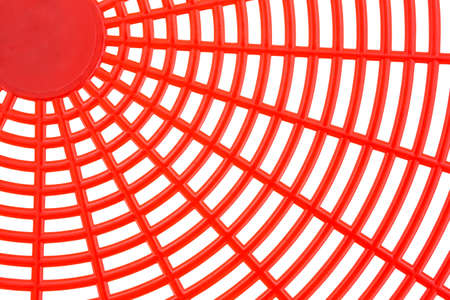 A very close view of a red fly swatter on a white background.の写真素材